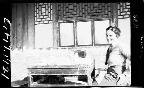 Woman sitting by table