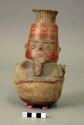 Pottery effigy jar- figure playing panpipe
