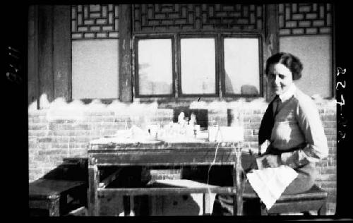 Janet Wulsin seated next to table