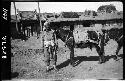 Man standing beside horse