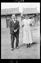 Man and woman stand outside building