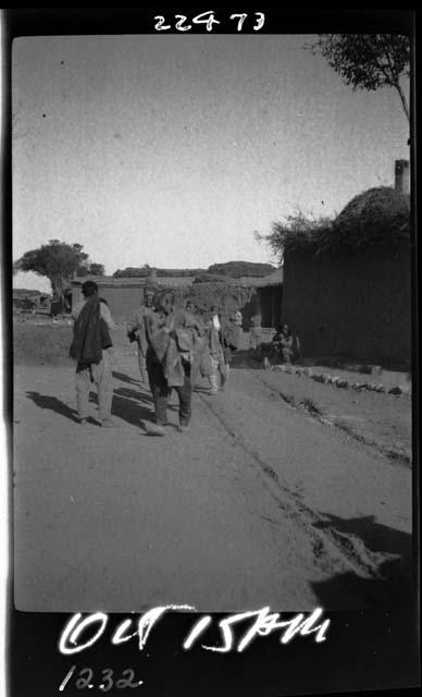 People walk down road