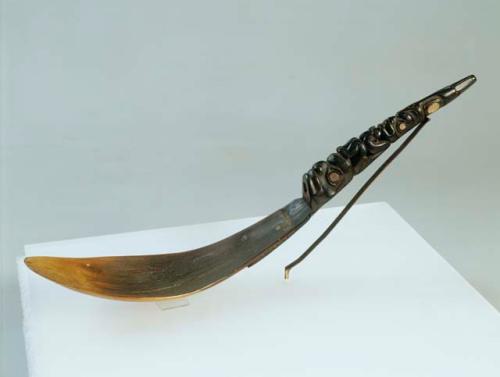 Ceremonial spoon depicting a bear and a loon.