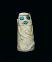 Small stone carving. Turquoise eyes and mouth. 1 3/8" (height).