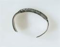Silver bracelet, central portion is twisted spiral; each end is +