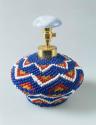 Atomizer bottle covered in blue and white beadwork