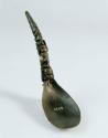 Horn ceremonial spoon depicting a frog, a hawk, and a squatting human with abalone inlay. 

