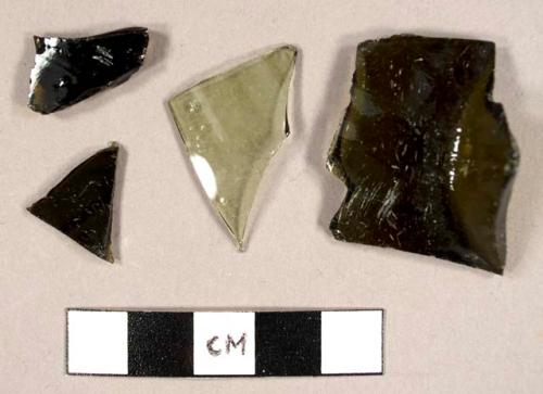 Curved olive green glass fragments, one possibly from a hurricane lamp