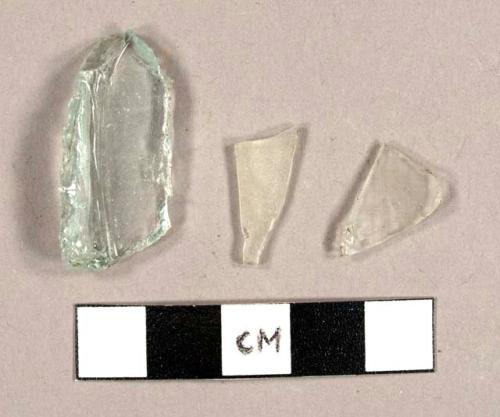 Miscellaneous glass fragments, two colorless curved fragments, one aqua flask base