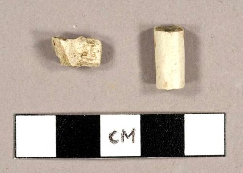 White kaolin pipe stem fragments, one with a spur and the letters "I" and "B" raised on either side