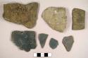 Miscellaneous stone fragments, including one slate roof tile fragment, slate bits, and cambridge mudstone