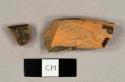 Black lead glazed redware sherds, one cup rim sherd and one pan rim sherd