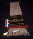 Brocaded dance sash depicting broad-face katcina, red, green, and black