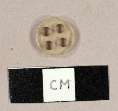 Colorless plastic button with four holes