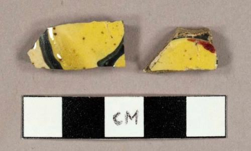 Earthenware sherds with handpainted yellow, red, blue, and white polychrome decoration on exterior and white interior