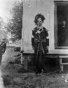 Man in native dress standing outside building