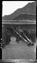 Crowd gathered around men holding two large horns/instruments