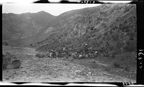 Large group of people at base of hill