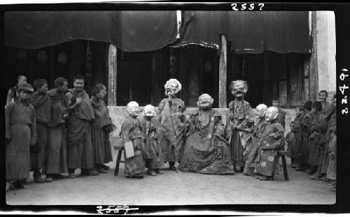 Crowd gathered around people in masks