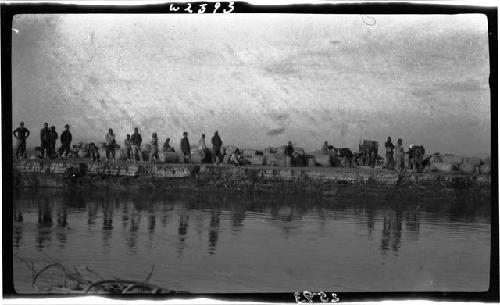 People gathered along a riverbank