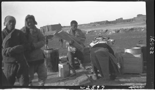 People standing around cargo