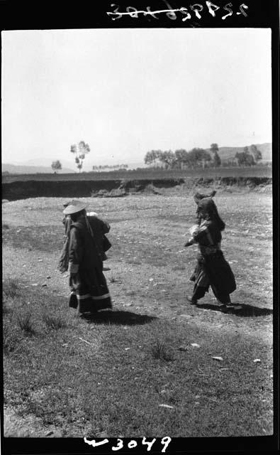 People walk down road