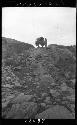 Person with wagon, standing at top of hill