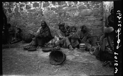 People sit against wall