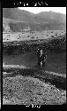 Women walk with buckets strapped to backs