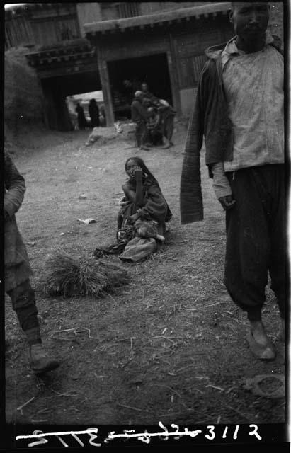 Woman seated on ground outside