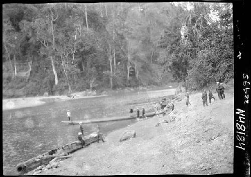 Riverbank, with people and boats