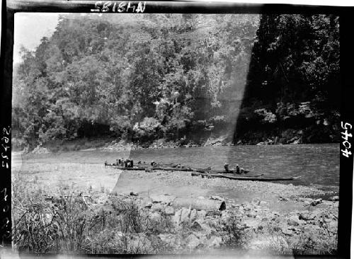 Riverbank, with people and boats