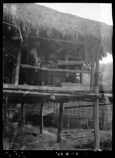 Open-air hut, with person on second level