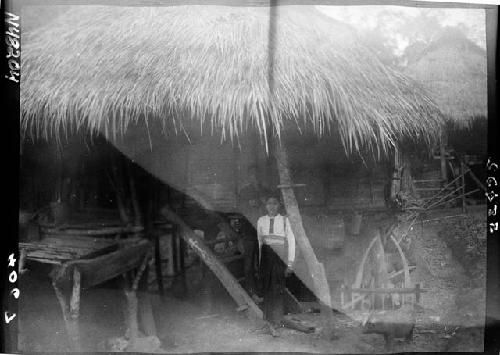 Children stand inside hut