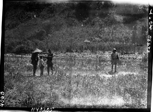 People stand in field