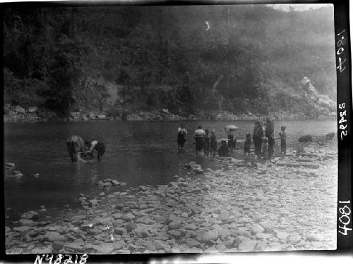 People gathered along riverbank