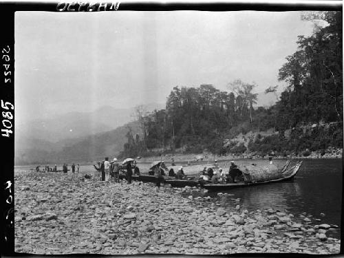 People boarding boats along riverbank