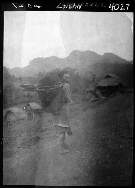 Person carrying basket strapped to back