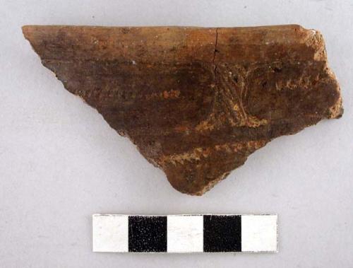 Ceramic rim sherd with incised curvilinear and punctate design