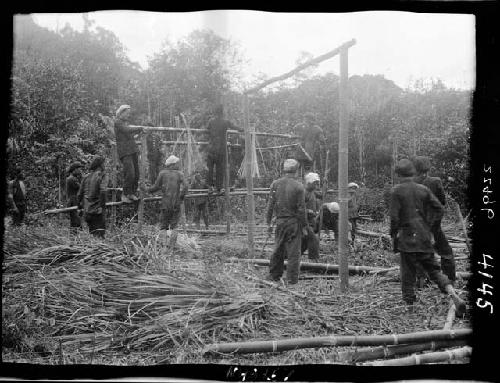 People build structure at edge of field