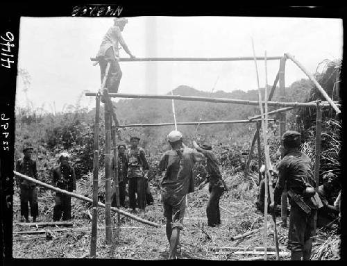 Workers construct building frame