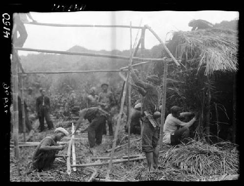 Workers construct frame of building