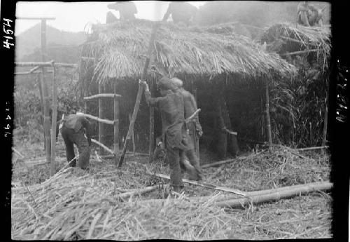 Workers building hut