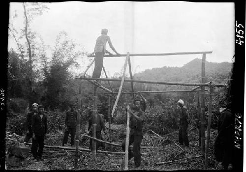 Workers construct building frame