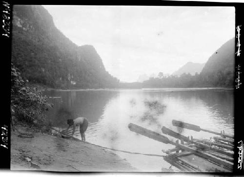 Person and boat along riverbank