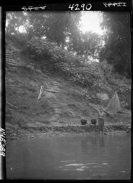 Woman standing by river