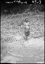 Woman stands on riverbank