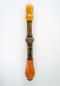 Cigarette holder made of amber segments inlaid with brass designs and +