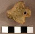 Clay pendant. possible representation of bird with outstretched wings. perforati