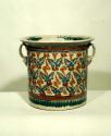 Large flat-bottomed polychrome pot; glazed and painted with a floral pattern in
